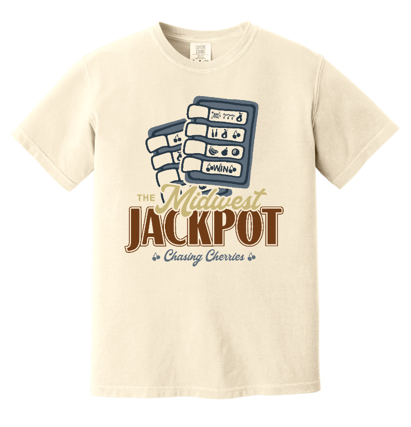 A cream-colored short-sleeve t-shirt with a retro graphic on the front featuring playing cards and the text 'The Midwest JACKPOT' and 'Chasing Cherries'.